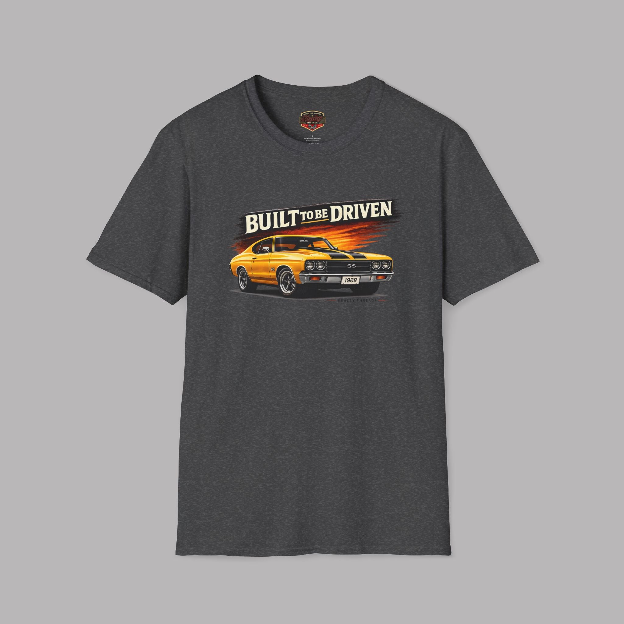 Dark heather t-shirt with a graphic of a car and 'Built to be Driven' text on a gray background