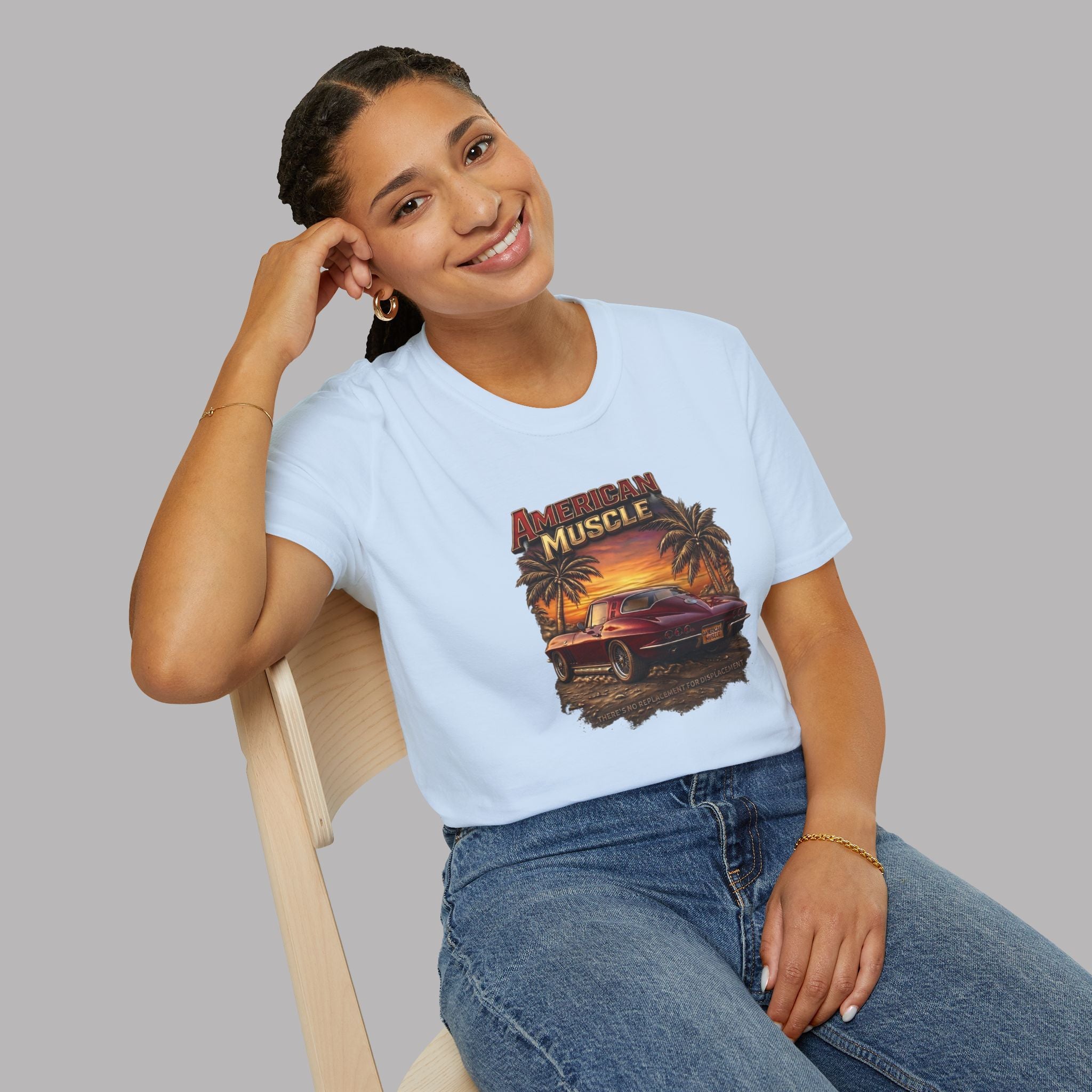 Person wearing a light blue t-shirt with a graphic design of a muscle car and palm trees.