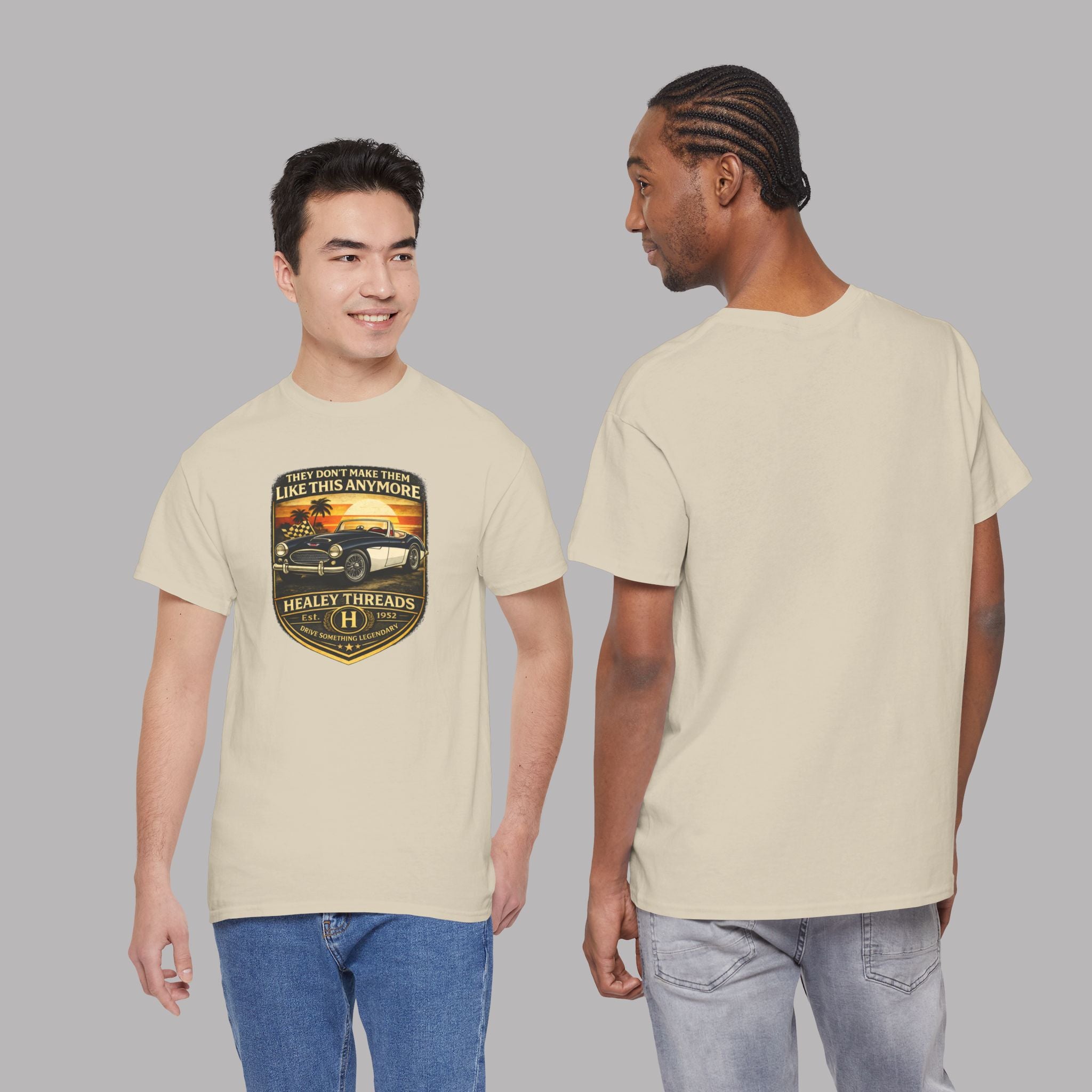 Two people wearing a sand t-shirt with a graphic car design on a gray background