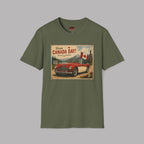 An military green short-sleeve crewneck t-shirt featuring a vintage-style 'Happy Canada Day!' graphic print on the chest, displayed against a solid gray background.