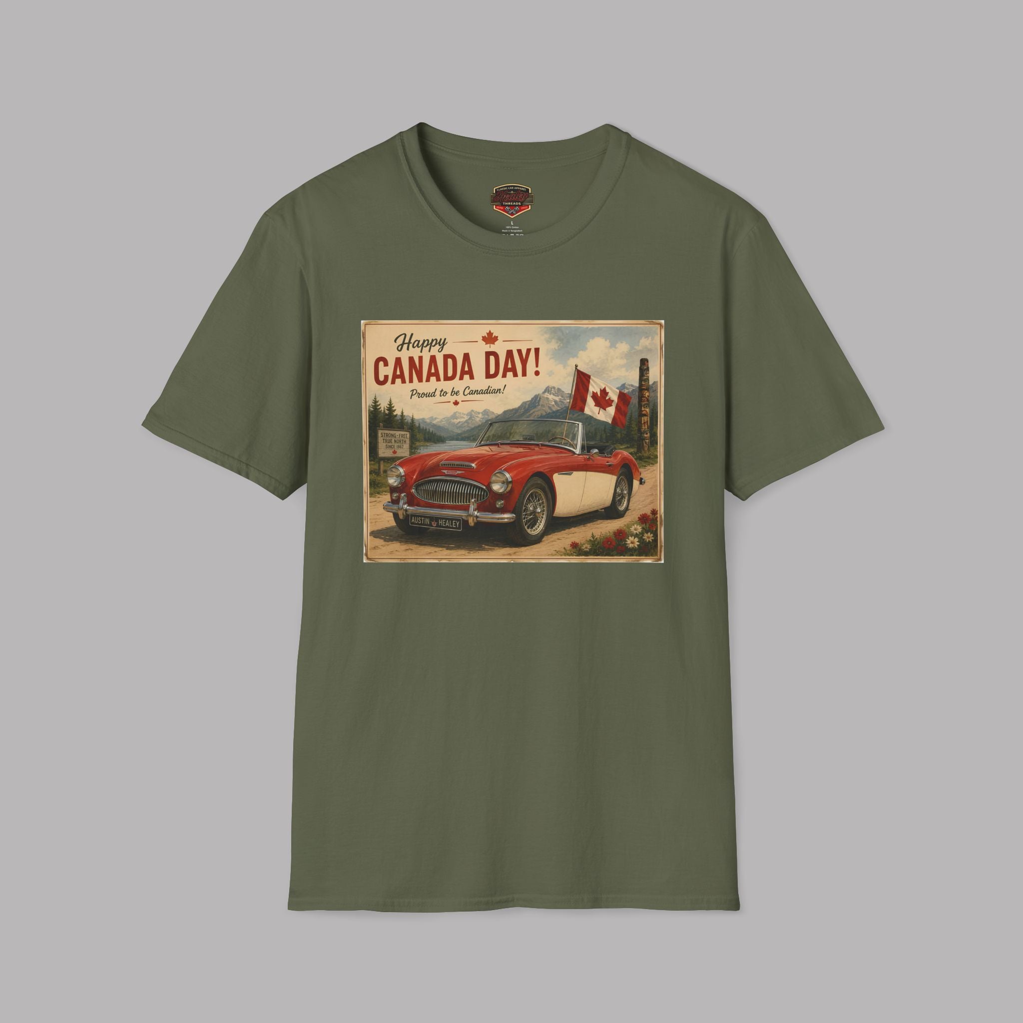An military green short-sleeve crewneck t-shirt featuring a vintage-style 'Happy Canada Day!' graphic print on the chest, displayed against a solid gray background.
