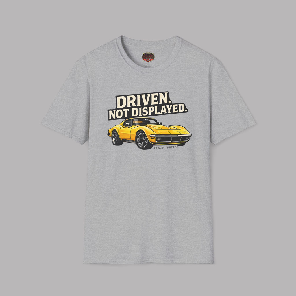 Sport gray t-shirt with a yellow muscle car graphic and text 'Driven. Not Displayed.' on a gray background