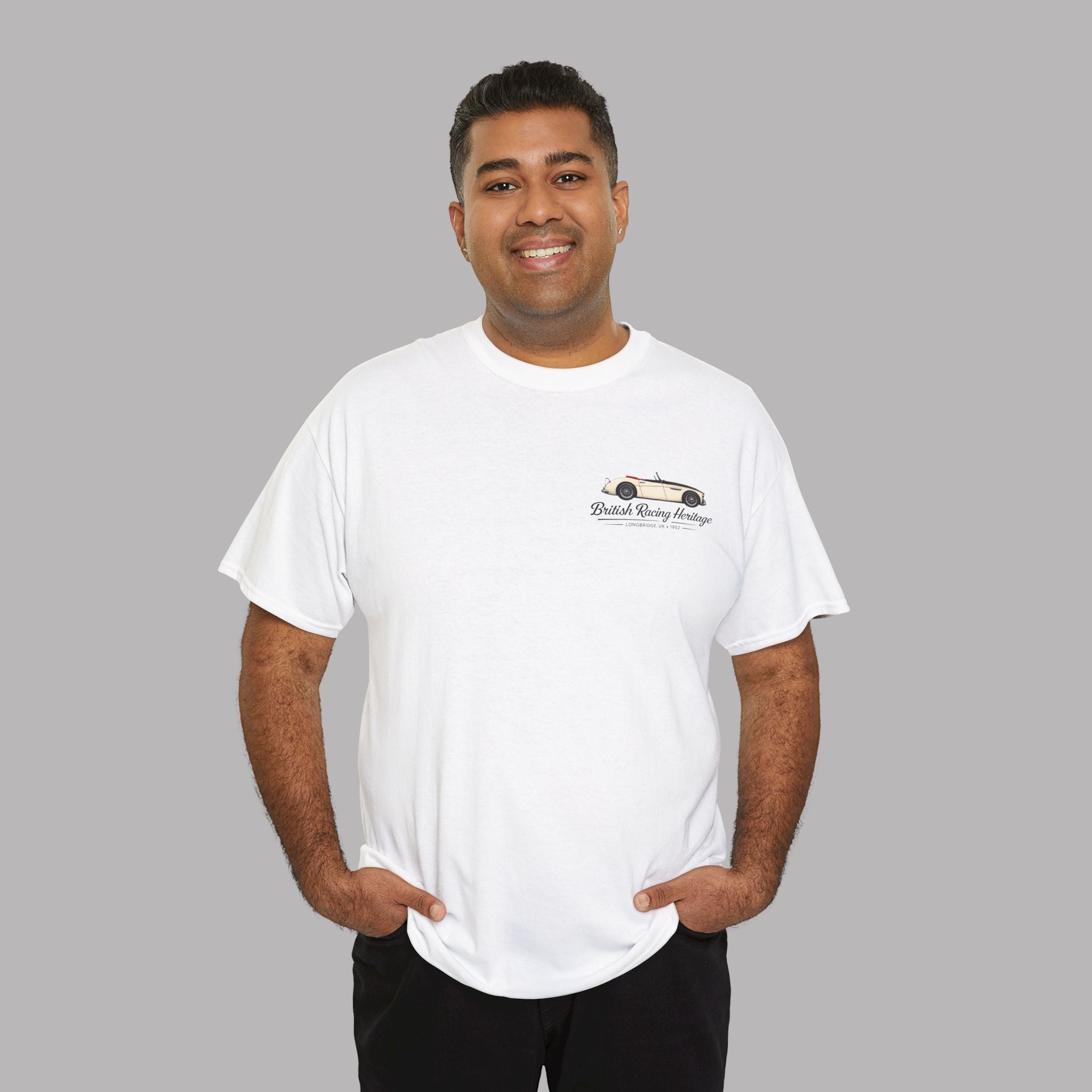 Man wearing a white t-shirt with a Healey car graphic and black text on a gray background