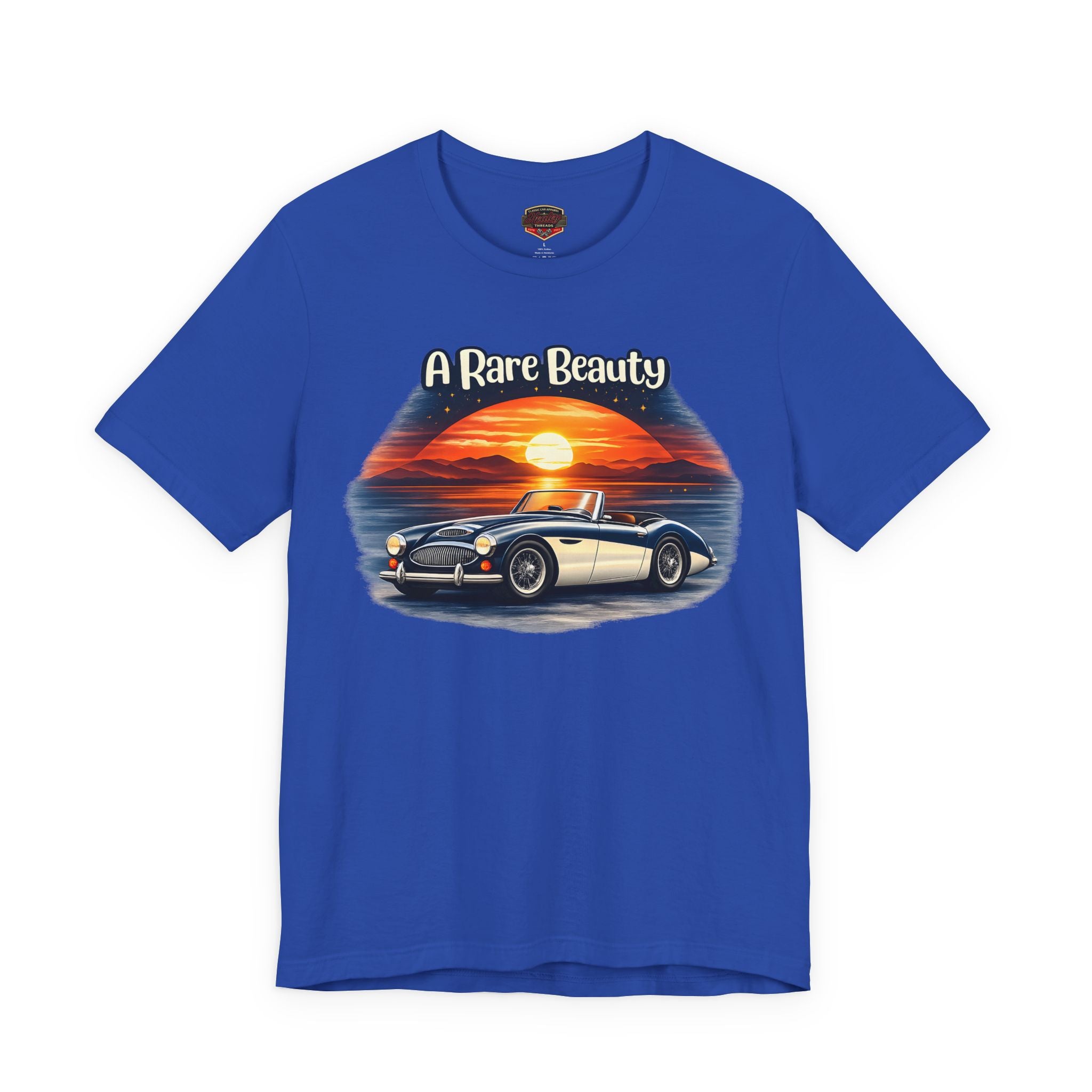 True blue t-shirt with a graphic of a vintage Healey car and sunset, labeled 'A Rare Beauty', on a white background.