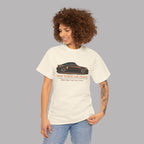 Woman wearing a white t-shirt with a classic car graphic and text on a plain background