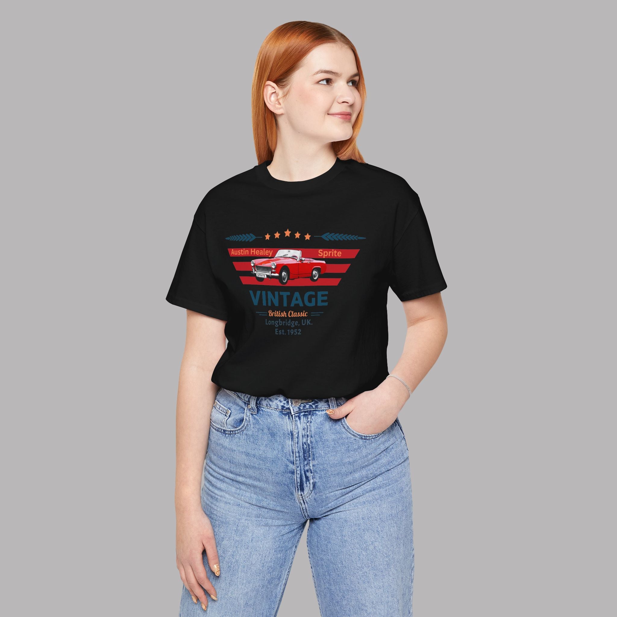Woman wearing a black t-shirt with a graphic car design on a gray background