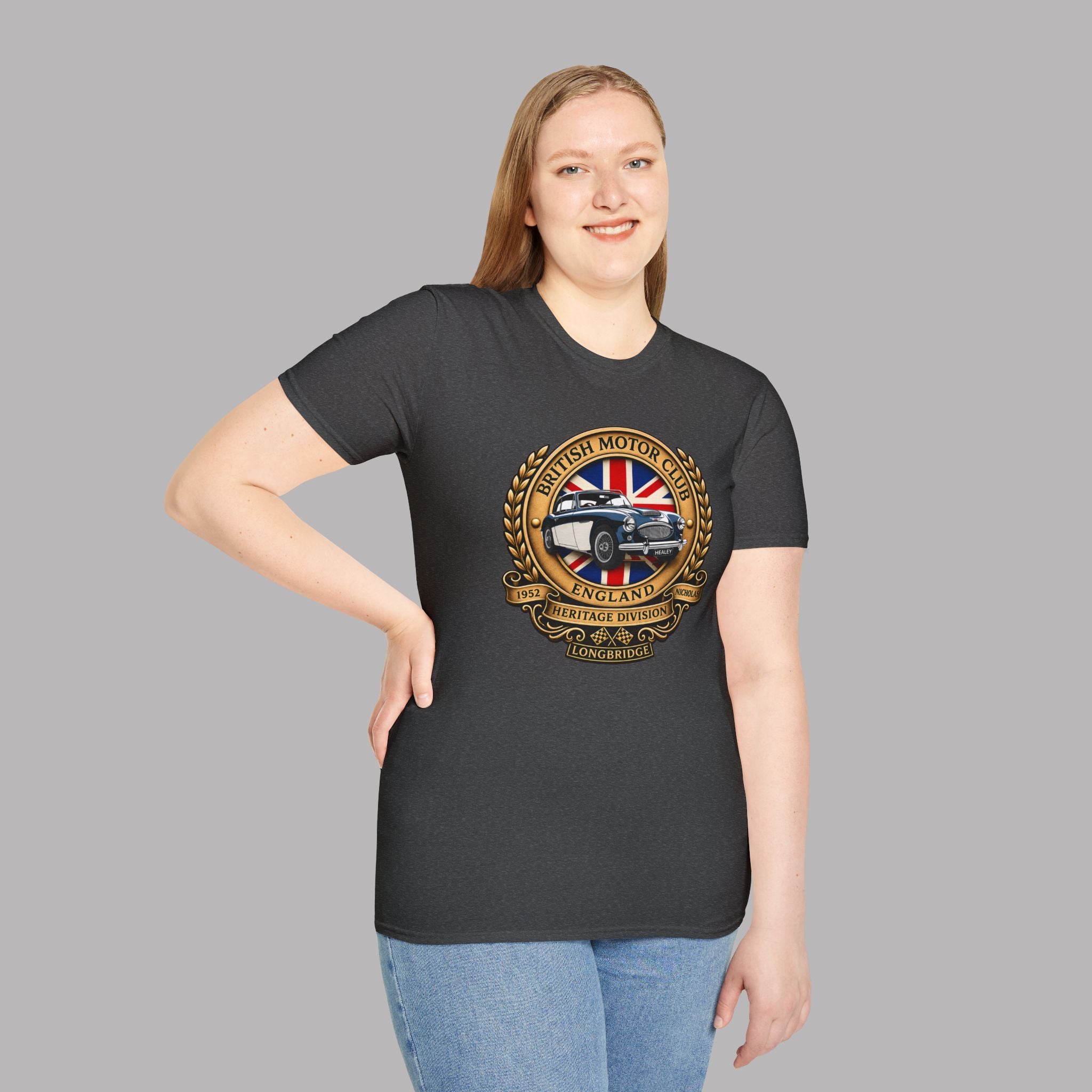 Woman wearing a dark heather t-shirt with a British Motor Heritage logo on a gray background 