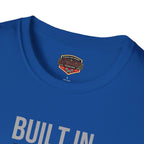 Royal blue t-shirt with a classic car graphic and brand logo on the collar against a white background