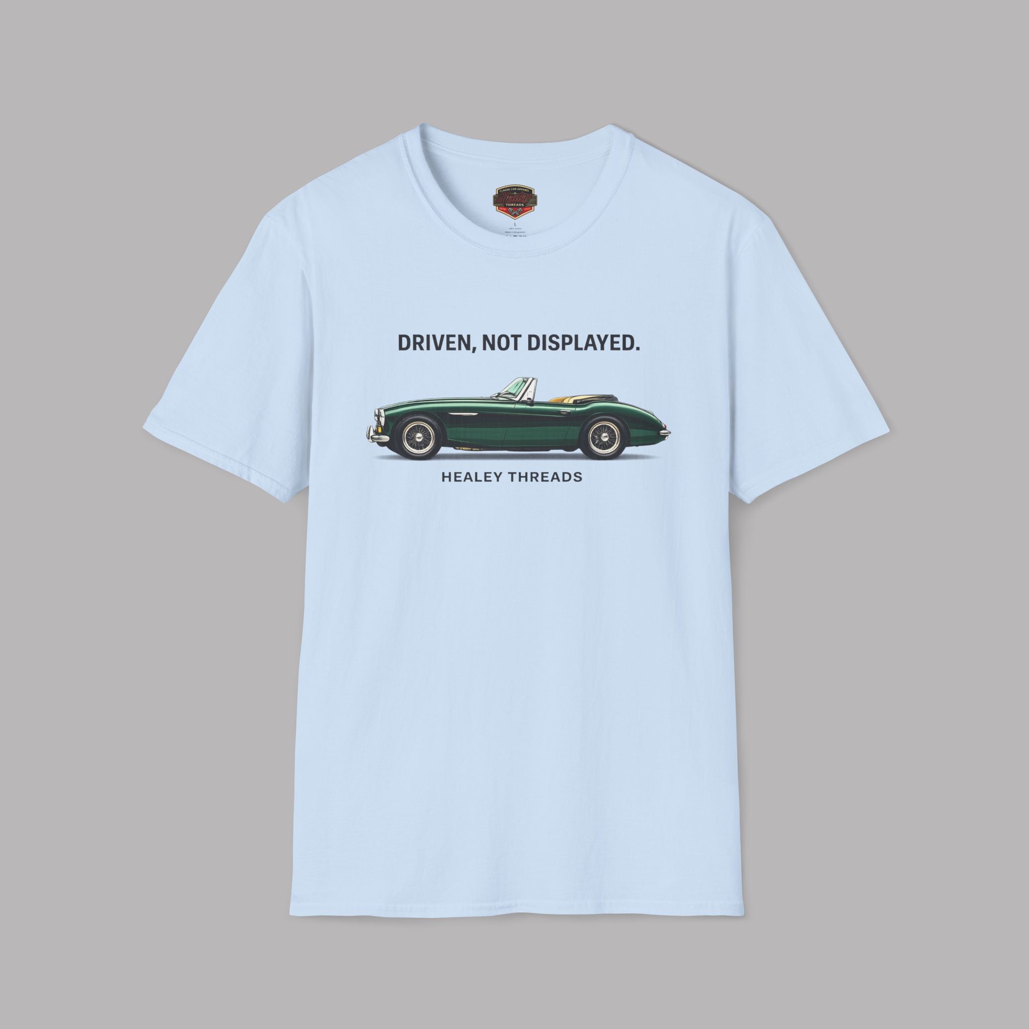 Light blue t-shirt with a green classic car graphic and text on a gray background