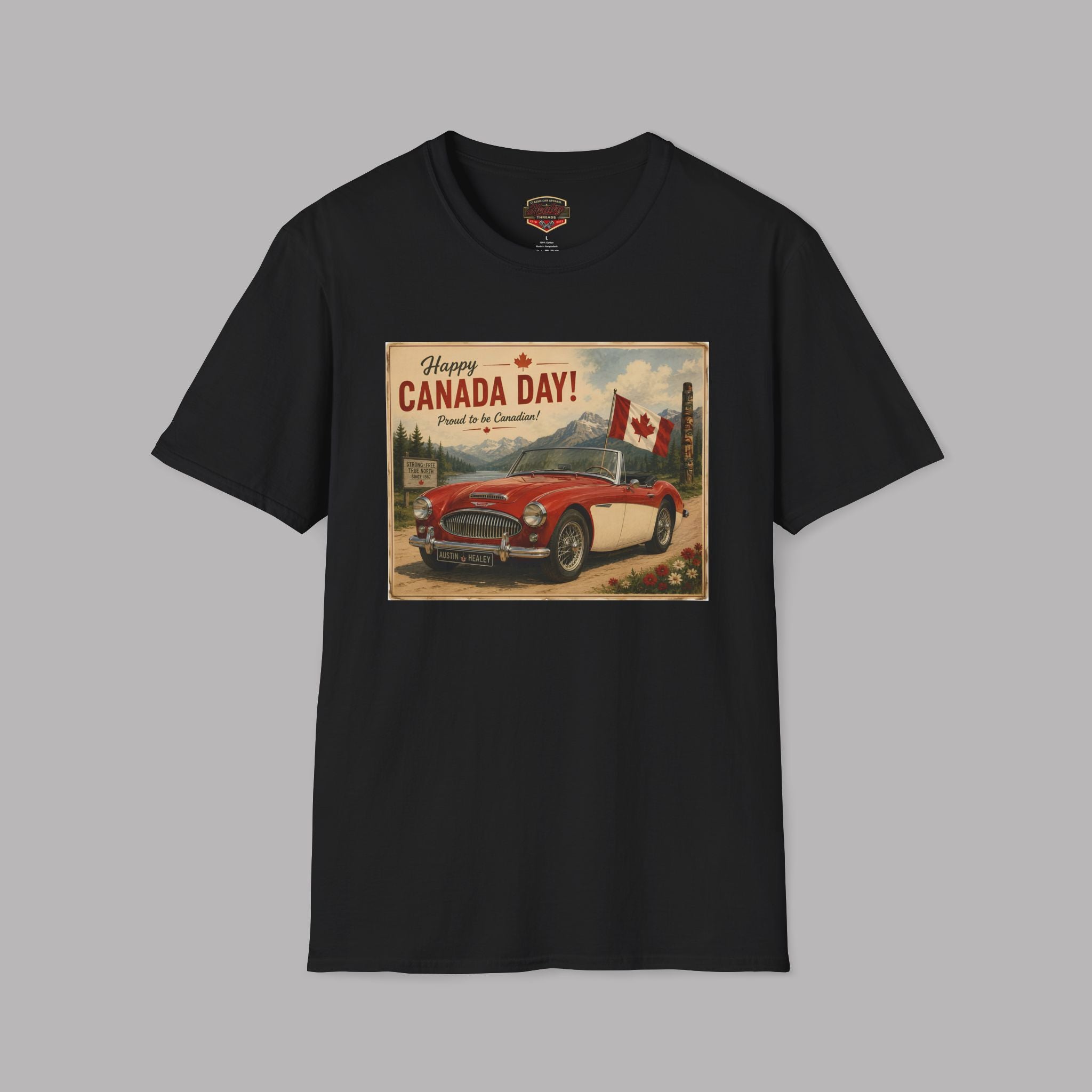 A black short-sleeve crewneck t-shirt featuring a vintage-style Canada Day graphic print on the chest, displayed against a solid gray background.