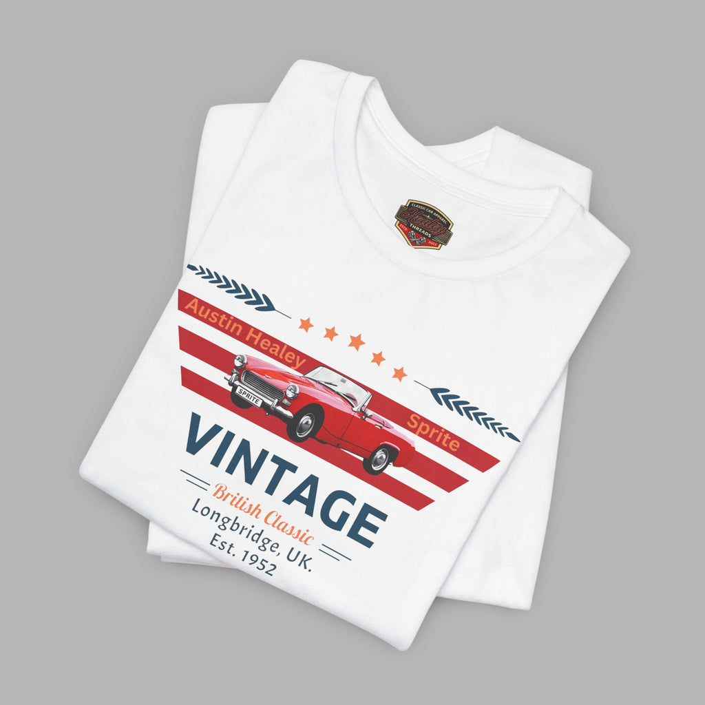 Folded white t-shirt with vintage car design on a gray background