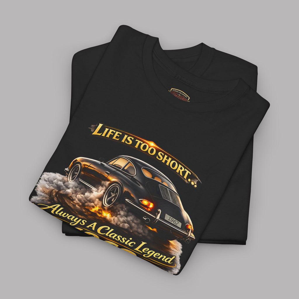 Folded black t-shirt with classic car graphic and text on a gray background