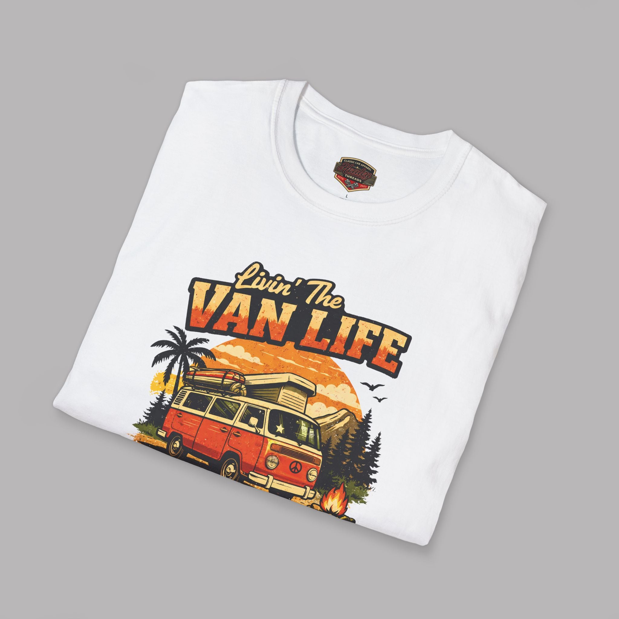 Folded white t-shirt with 'Livin' The Van Life' graphic design on a gray background