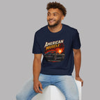 Man wearing a navy blue t-shirt with an 'American Muscle' car graphic design on a gray background