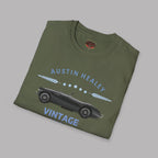 Folded military green t-shirt with Austin Healey vintage car design on a gray background