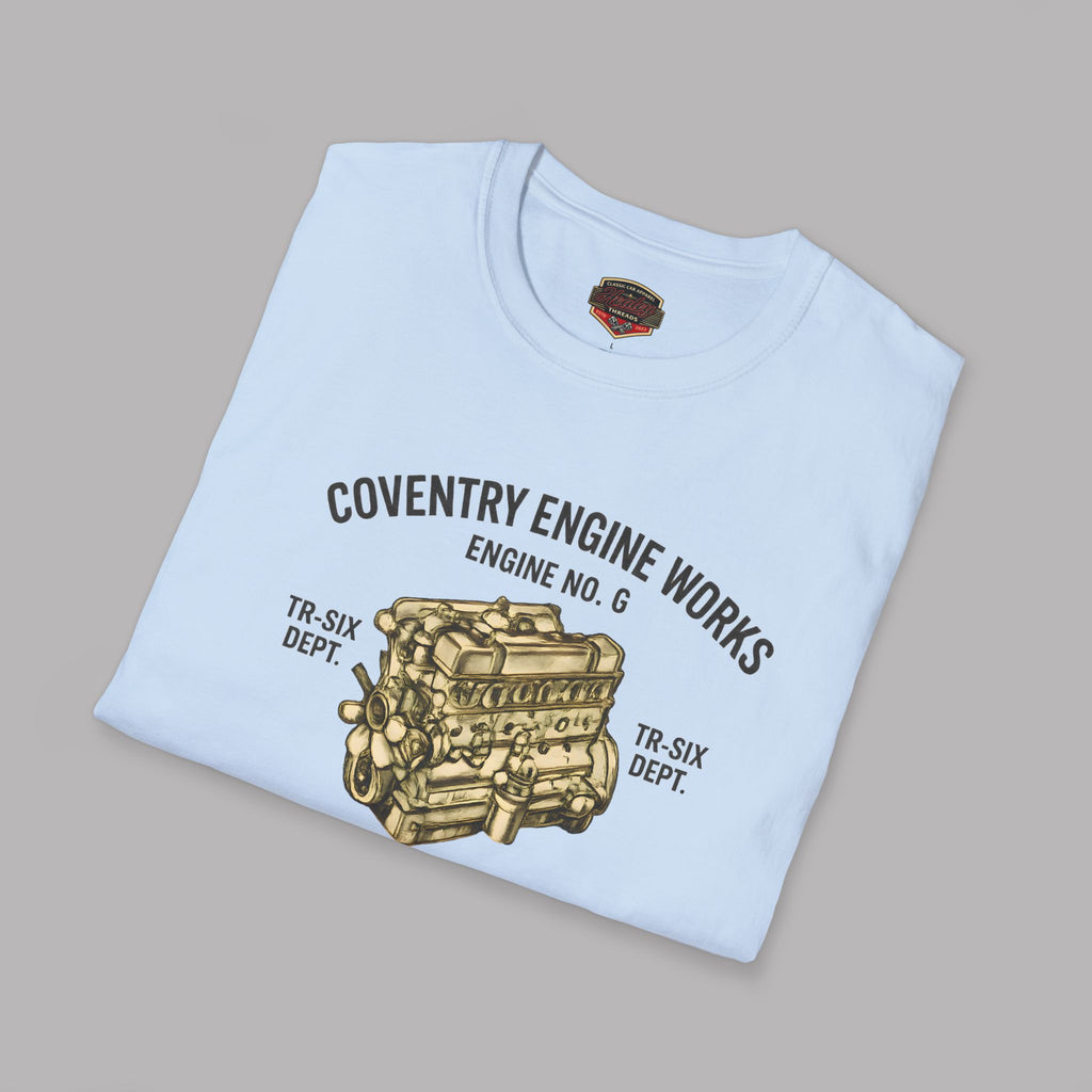 Folded light blue t-shirt with Coventry Engine Works graphic on a gray background