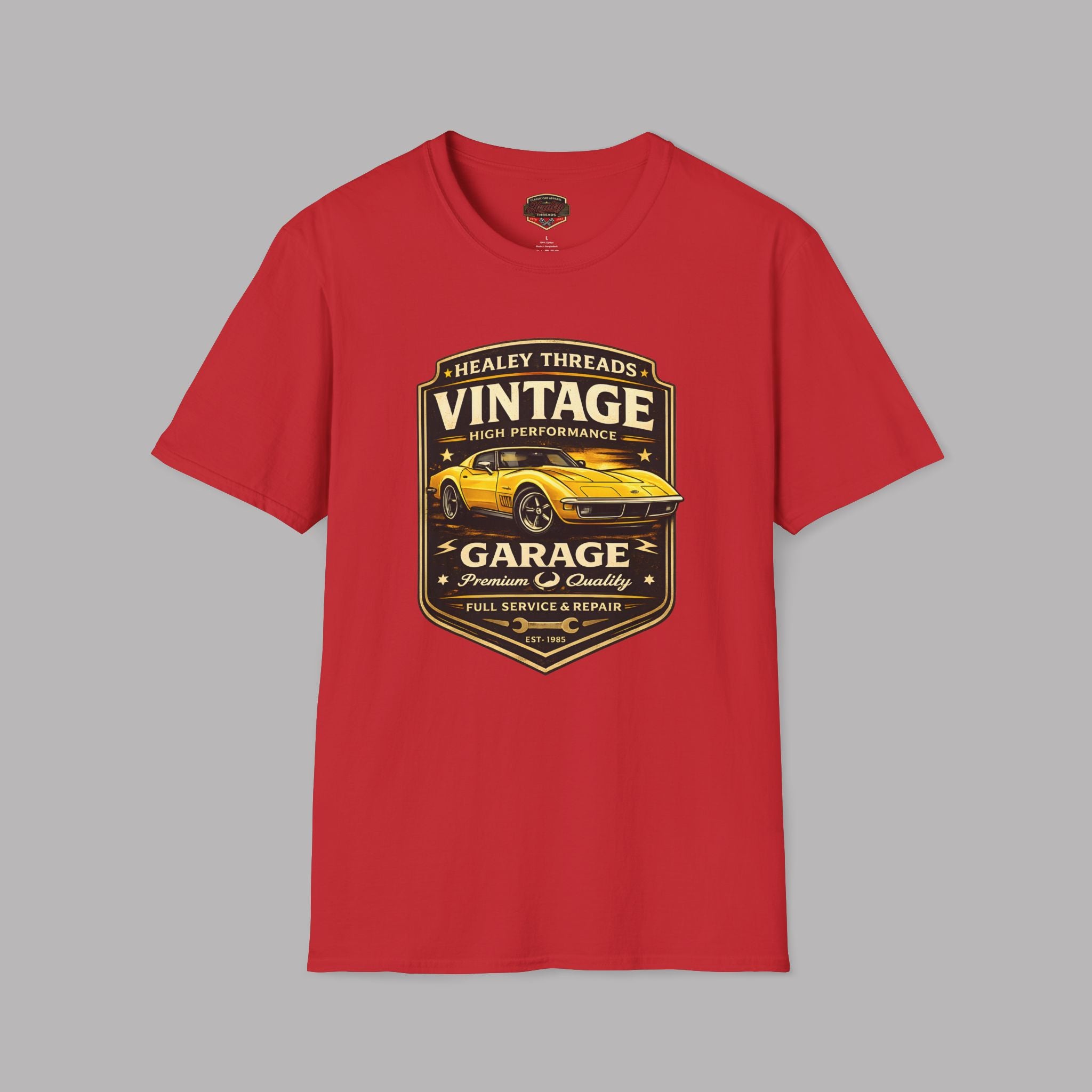 Red t-shirt with vintage classic car graphic on a gray background