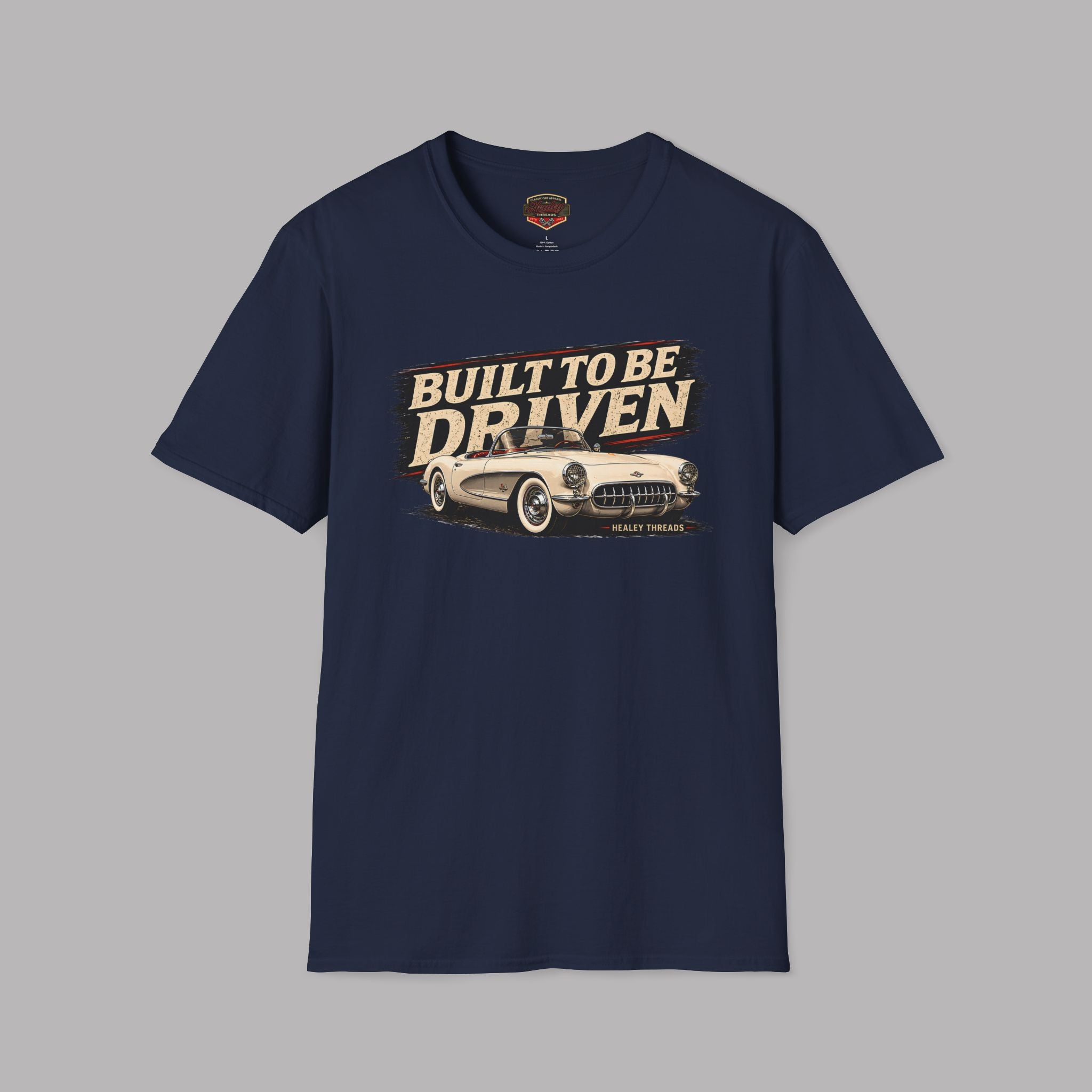 Navy blue t-shirt with 'Built to be Driven' graphic on a gray background