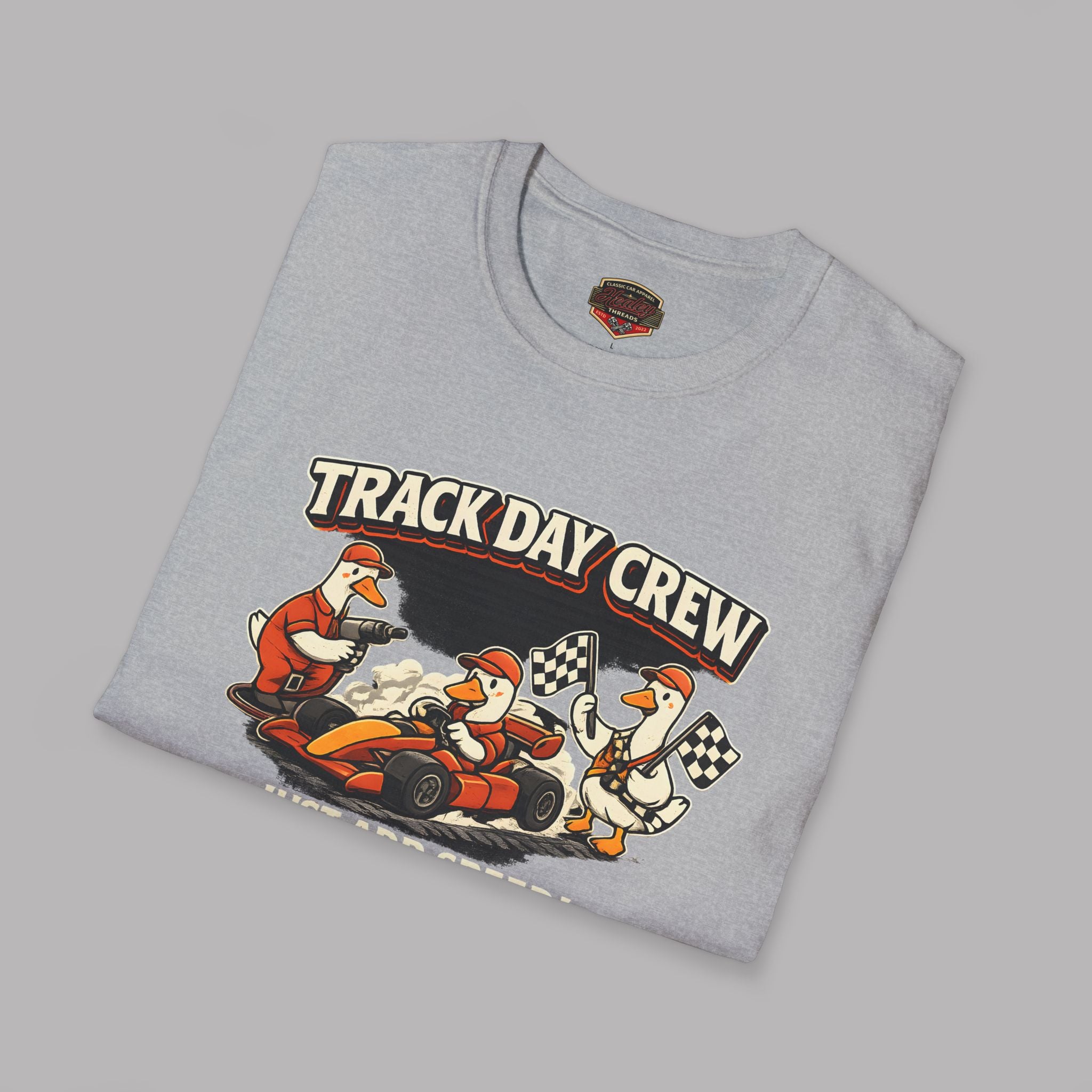 Folded gray t-shirt with 'Track Day Crew' graphic on a gray background