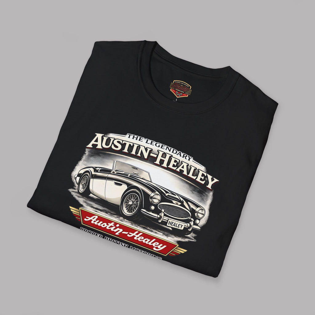 Folded black t-shirt with Austin-Healey car graphic on a gray background