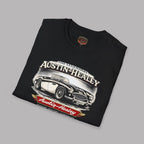Folded black t-shirt with Austin-Healey car graphic on a gray background