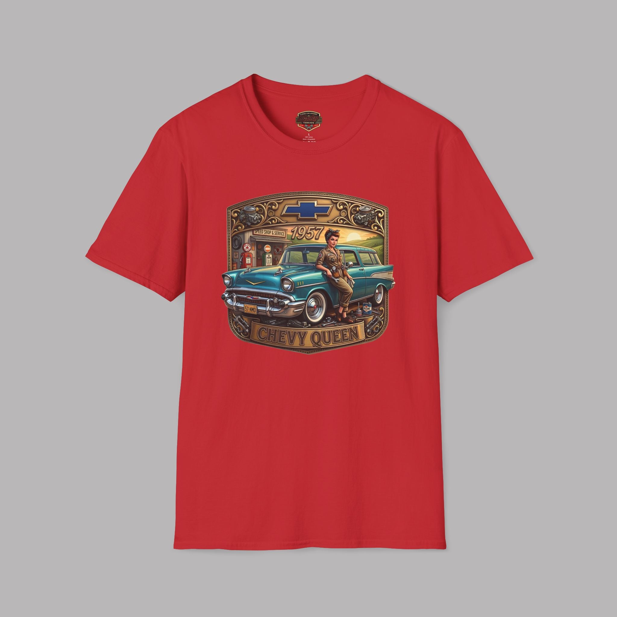 A red short-sleeve crewneck t-shirt featuring a vintage-style graphic print of a teal 1957 Chevrolet station wagon with a woman sitting on it, framed by a gold and brown border with the text 'CHEVY QUEEN'.