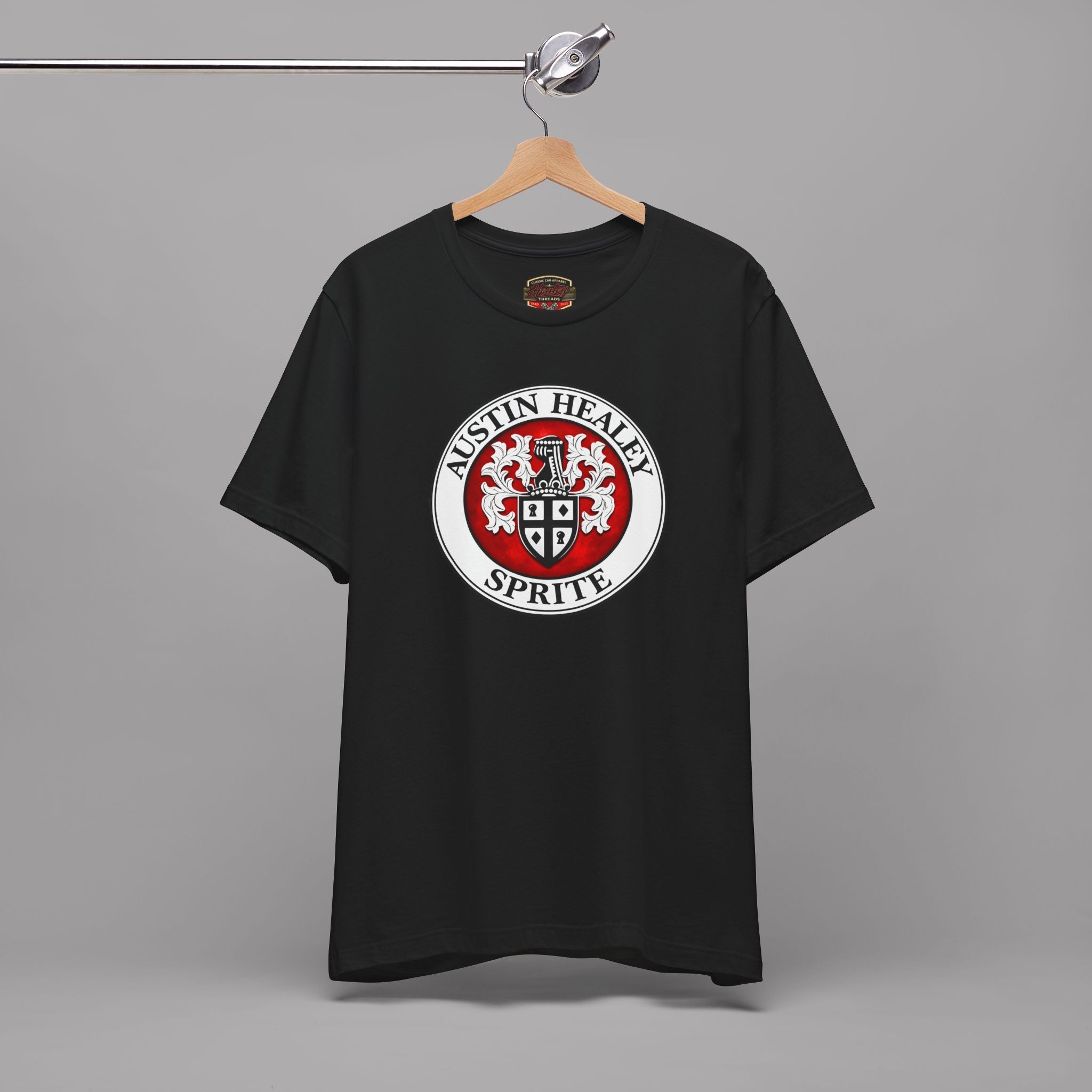 Black t-shirt with Austin Healey Sprite logo on a hanger against a gray background