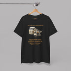 Black t-shirt with graphic design and text on a hanger against a gray background