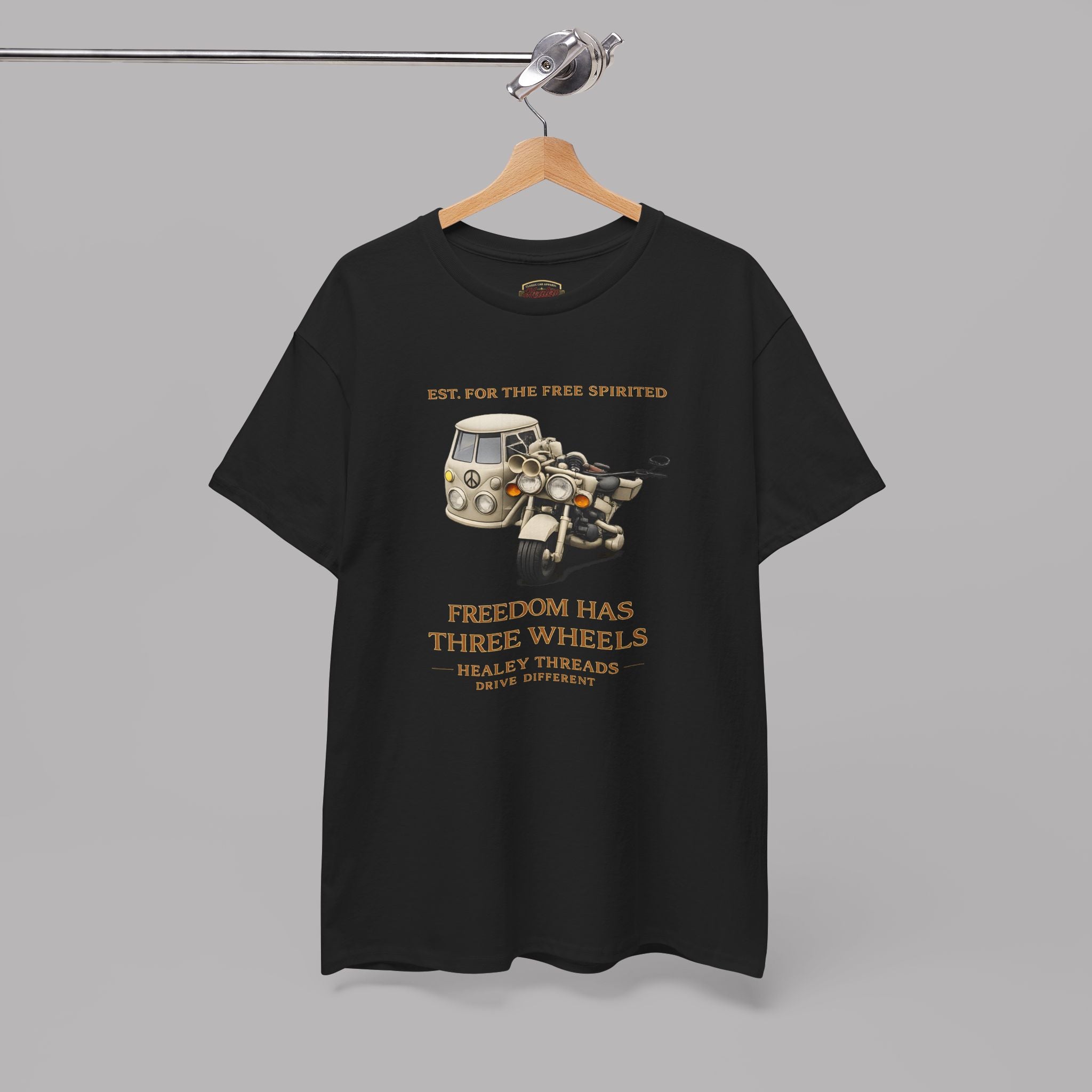 Black t-shirt with graphic design and text on a hanger against a gray background