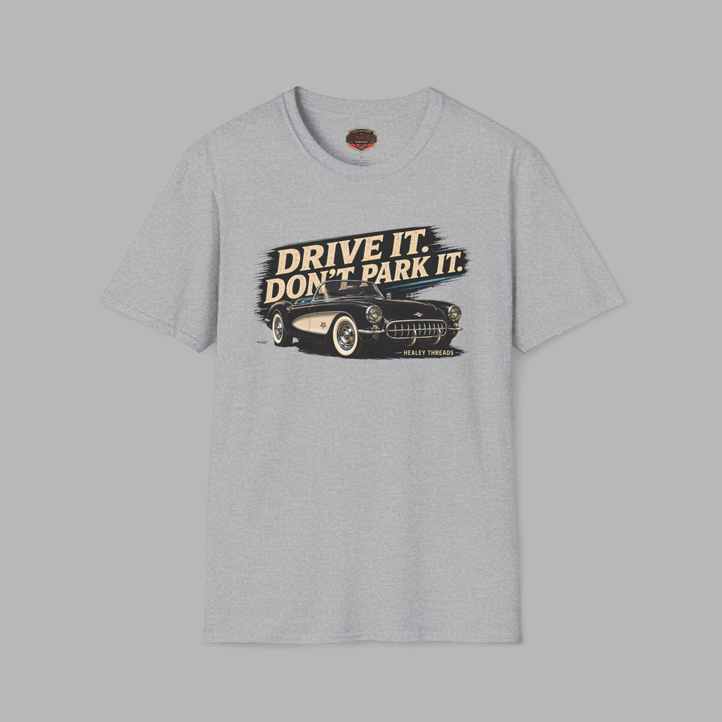 Gray t-shirt with a graphic of a car and text 'Drive it. Don't park it.' on a gray background
