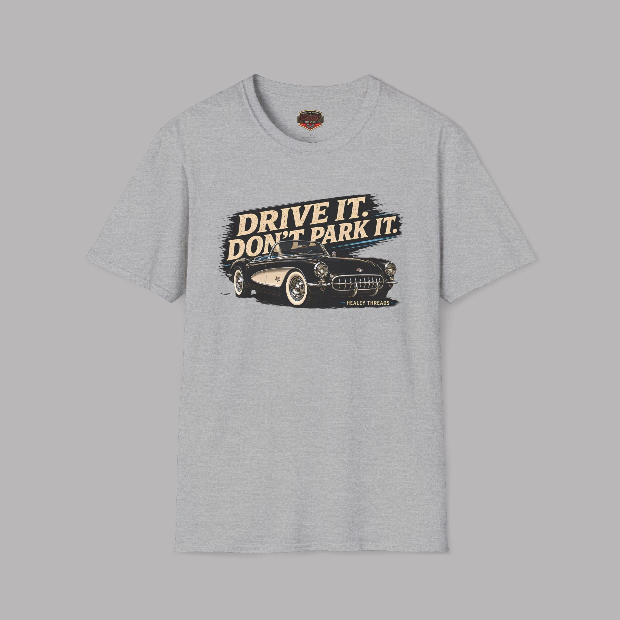 Gray t-shirt with a graphic of a car and text 'Drive it. Don't park it.' on a gray background