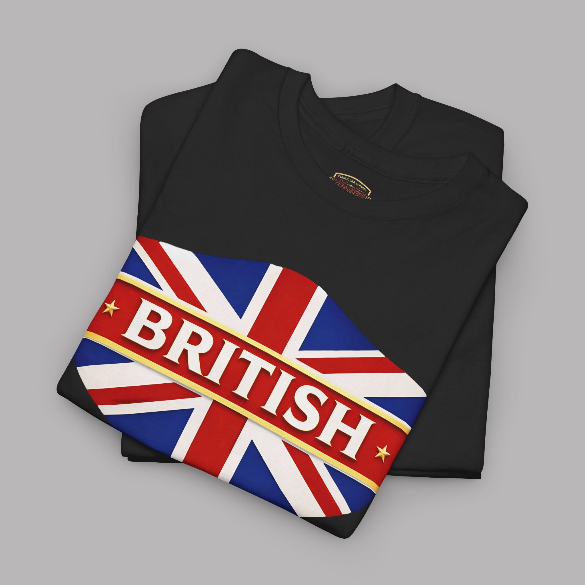 Folded black t-shirt with a Union Jack design and 'BRITISH' text on a gray background