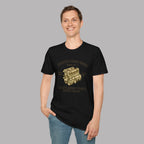 Man wearing a black t-shirt with a gold 'Coventry Engine Works' graphic and text on a gray background