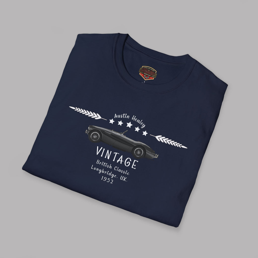 Folded navy blue t-shirt with vintage car design on a gray background