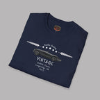 Folded navy blue t-shirt with vintage car design on a gray background