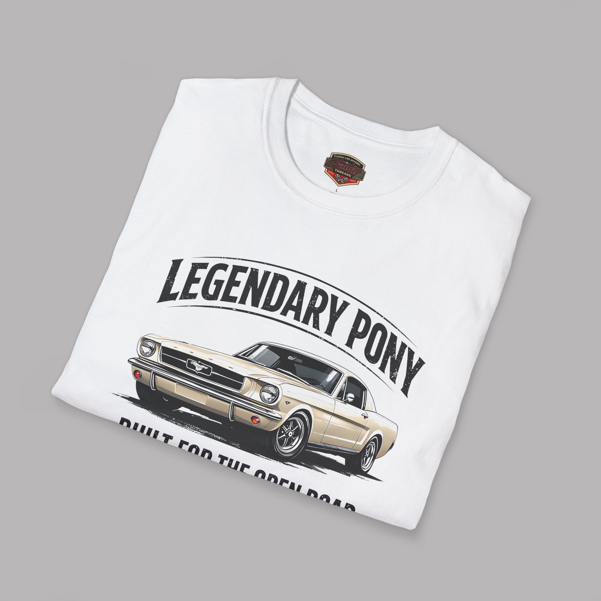 Folded white t-shirt with a graphic of a classic car and text 'Legendary Pony' on a gray background
