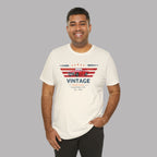 Man wearing a white t-shirt with a classic car graphic design on a gray background