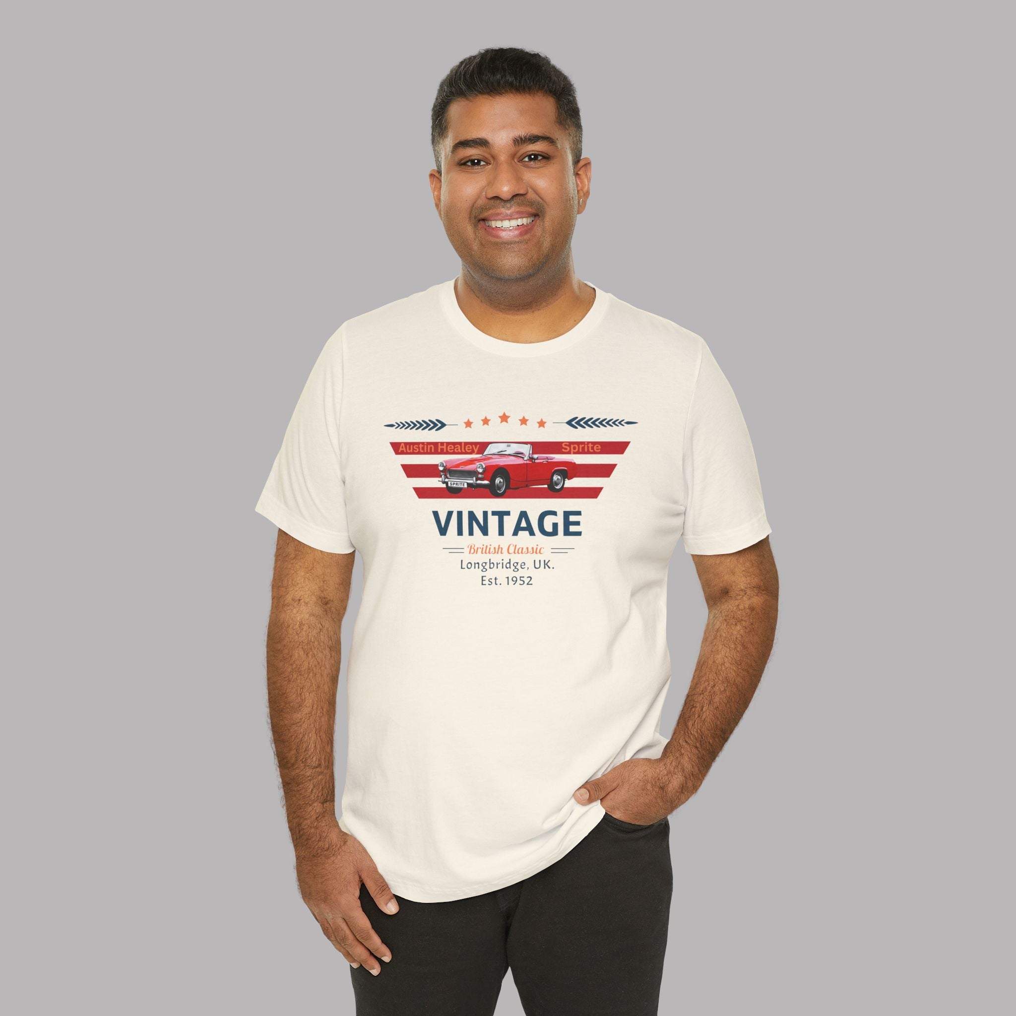 Man wearing a white t-shirt with a classic car graphic design on a gray background