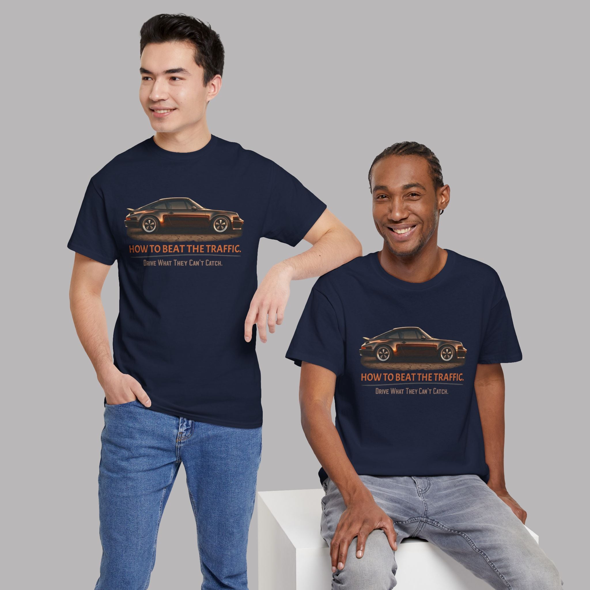 Two people wearing navy blue t-shirts with a classic car graphic design and text on a gray background
