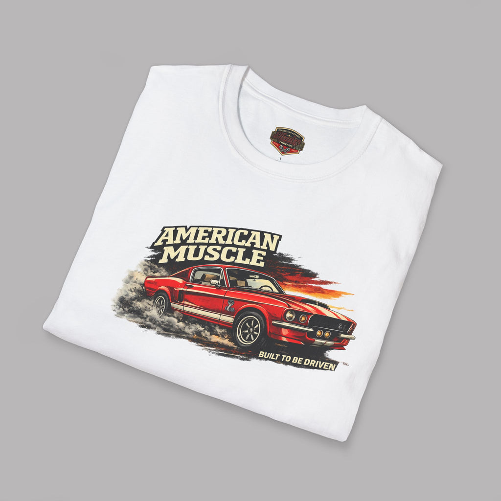 Folded white t-shirt with red car graphic and 'American Muscle' text on a gray background