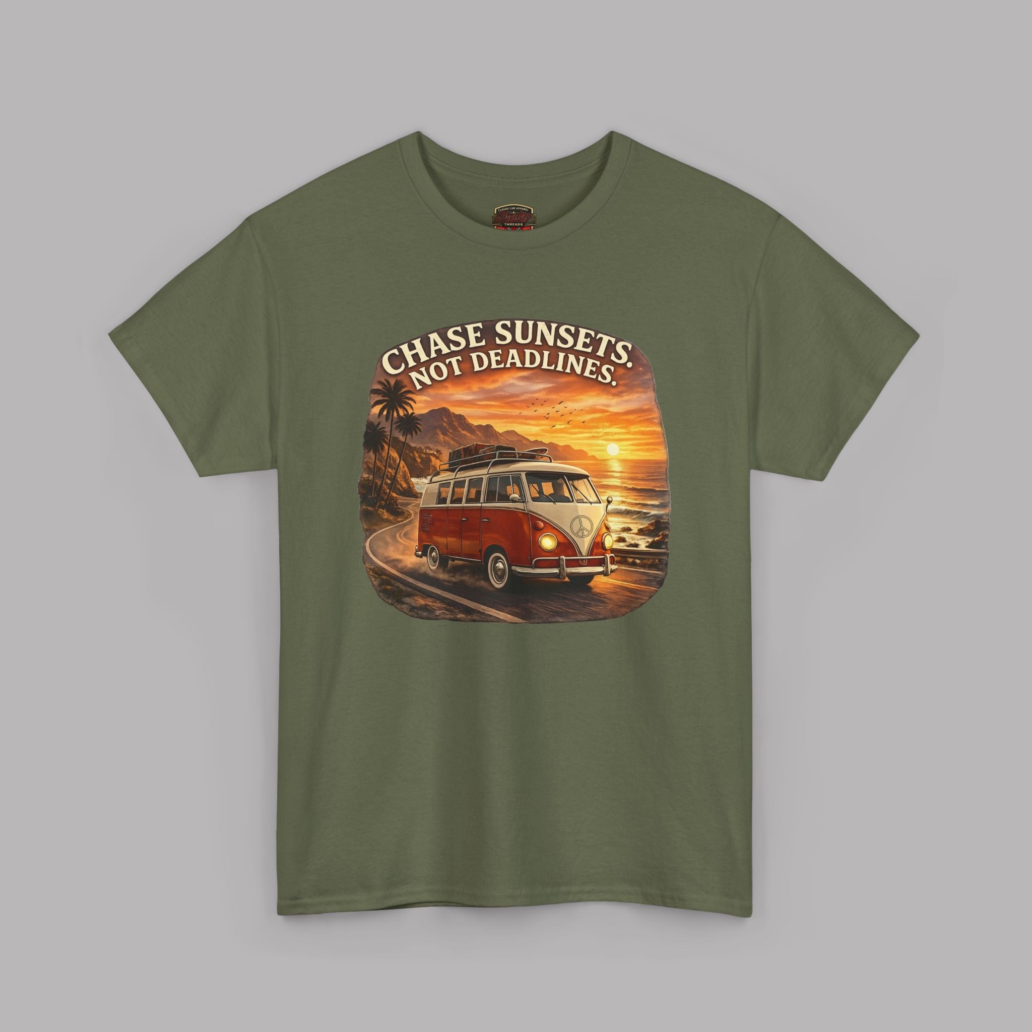 Military green t-shirt with a graphic of a classic van and sunset text on a gray background
