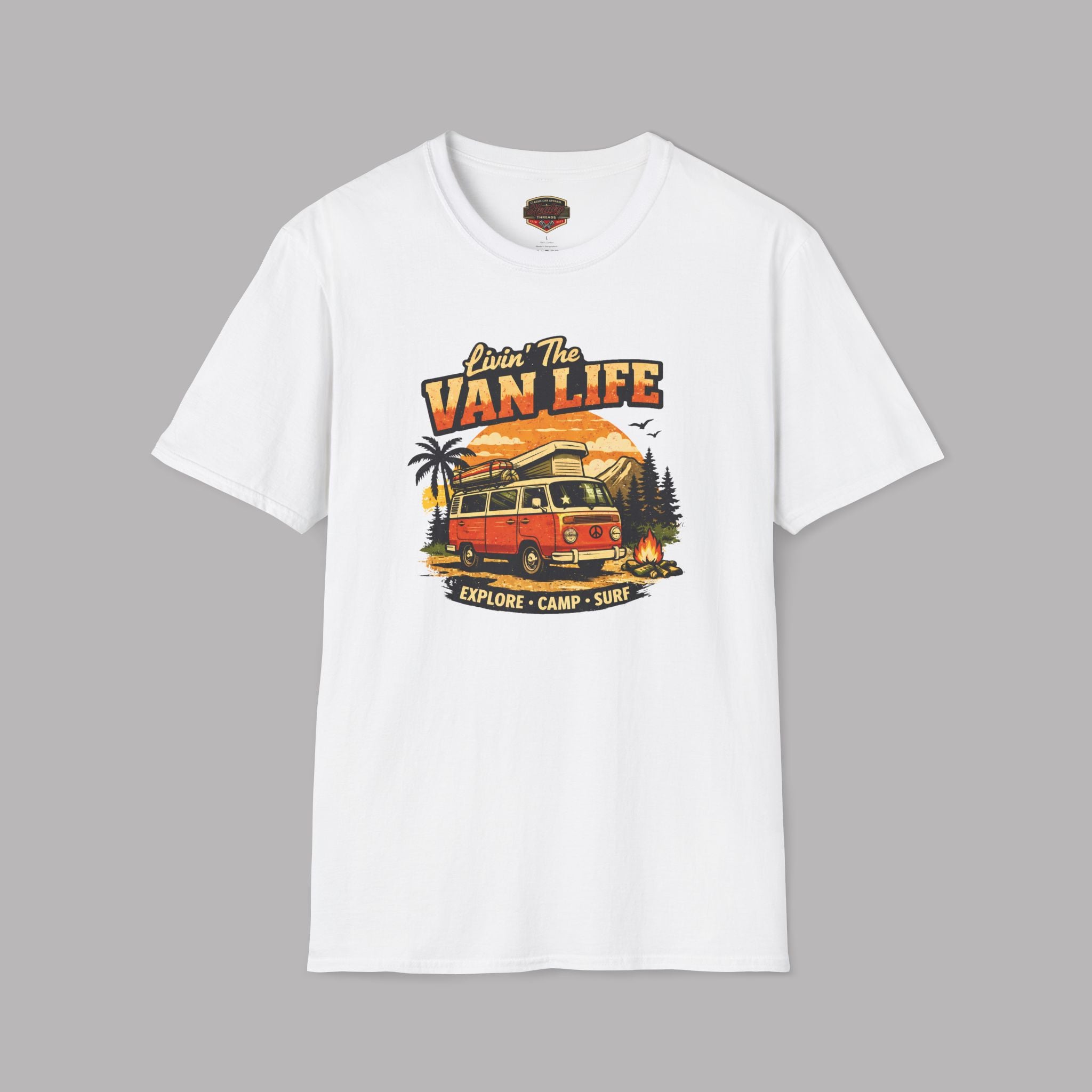 White t-shirt with 'Van Life' graphic design featuring a van, palm trees, and sunset on a gray background.