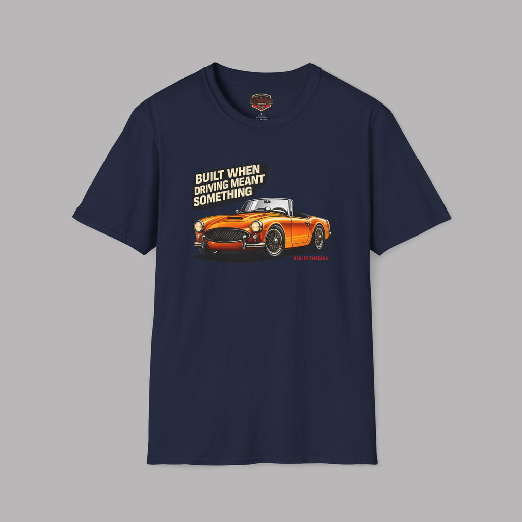 Navy blue t-shirt with orange car graphic and text on a gray background