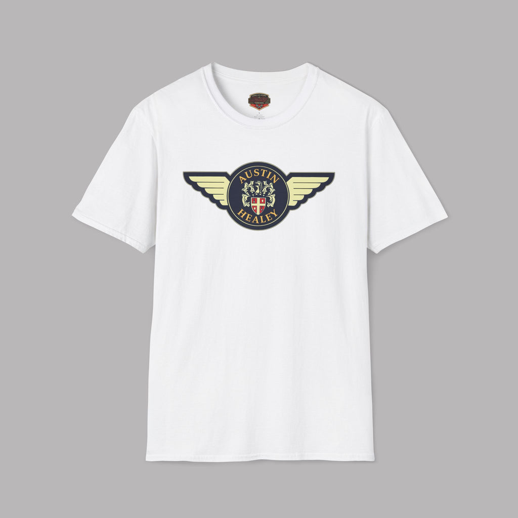 Austin Healey winged badge logo with navy and gold circular emblem, heraldic shield, and cream wings on a white t-shirt flat on gray background