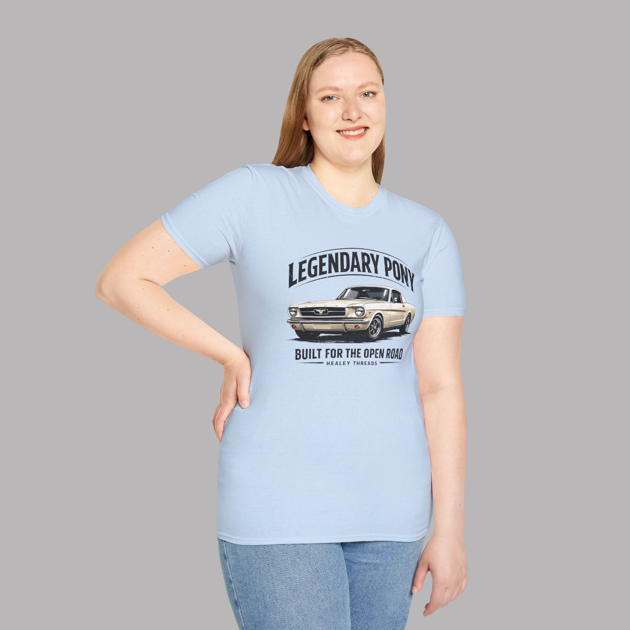 Woman wearing a light blue t-shirt with a classic car graphic and text on a gray background