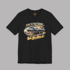 Black t-shirt with classic car graphic and text on a gray background