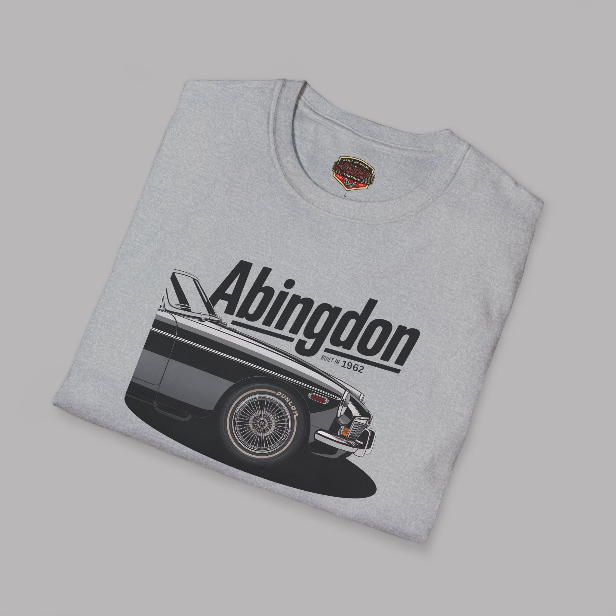 Folded gray t-shirt with classic car graphic and 'Abingdon' text on a gray background