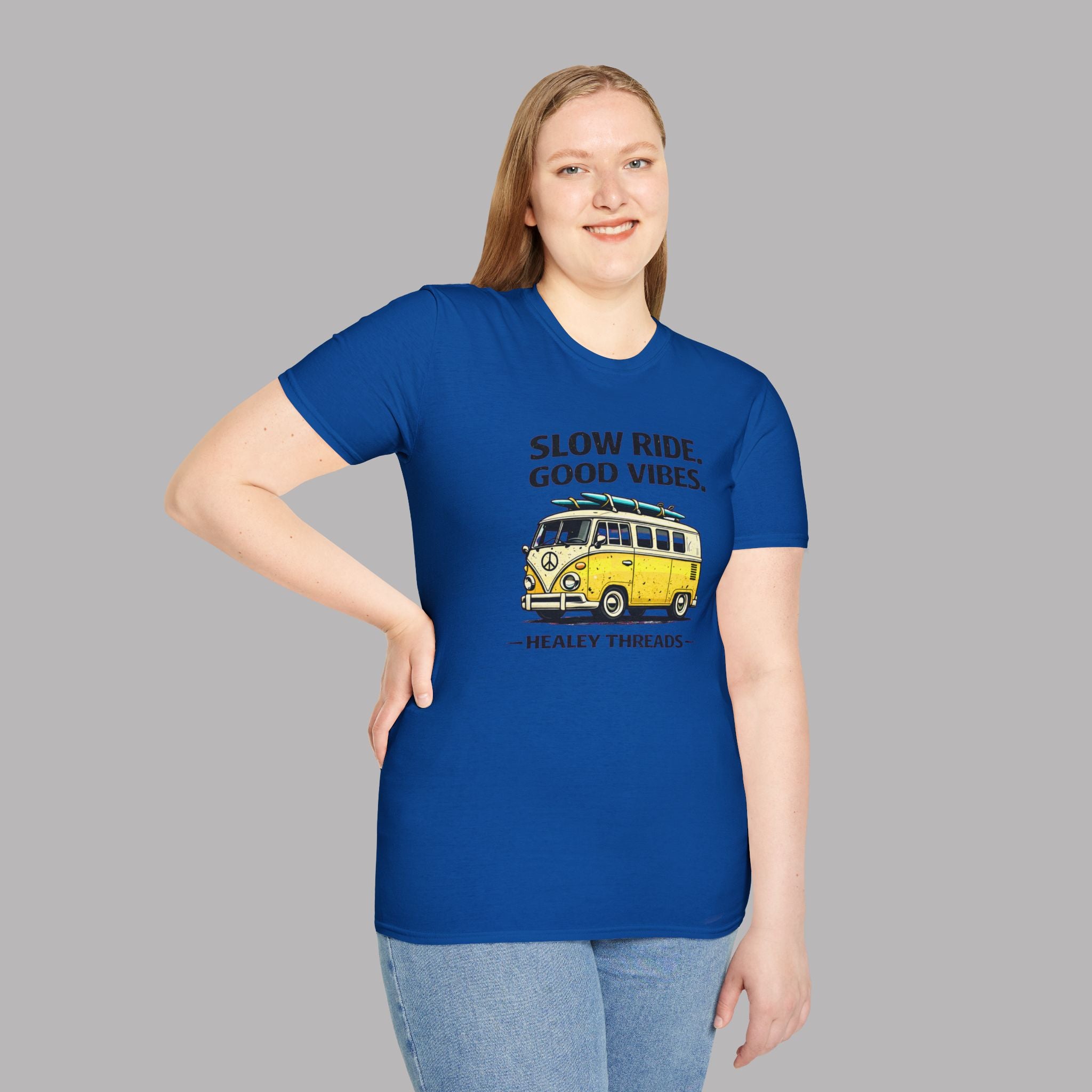 Woman wearing a royal blue t-shirt with a graphic design and text on a gray background