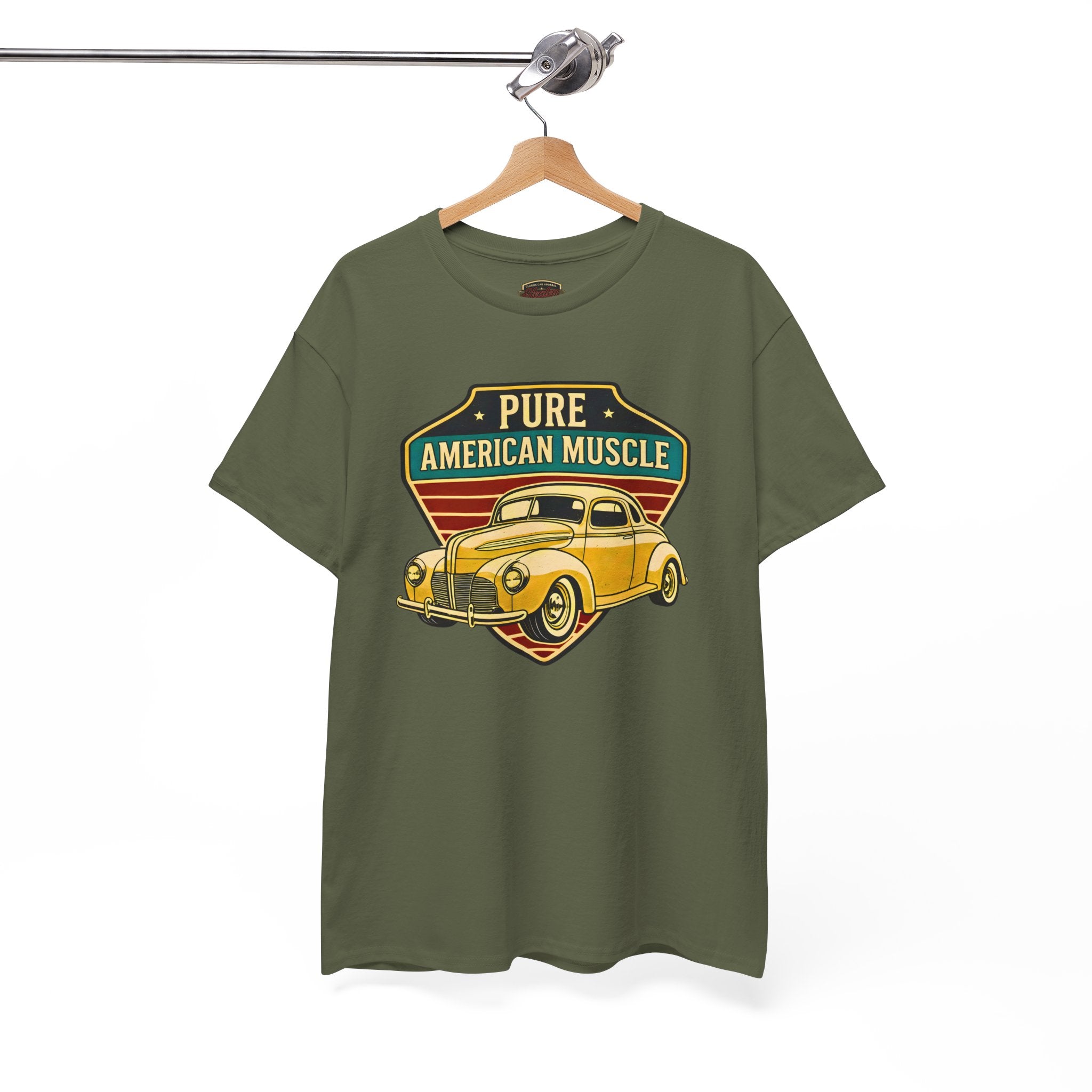 Military green t-shirt with a yellow vintage car graphic and 'Pure American Muscle' text on a hanger against a white background.