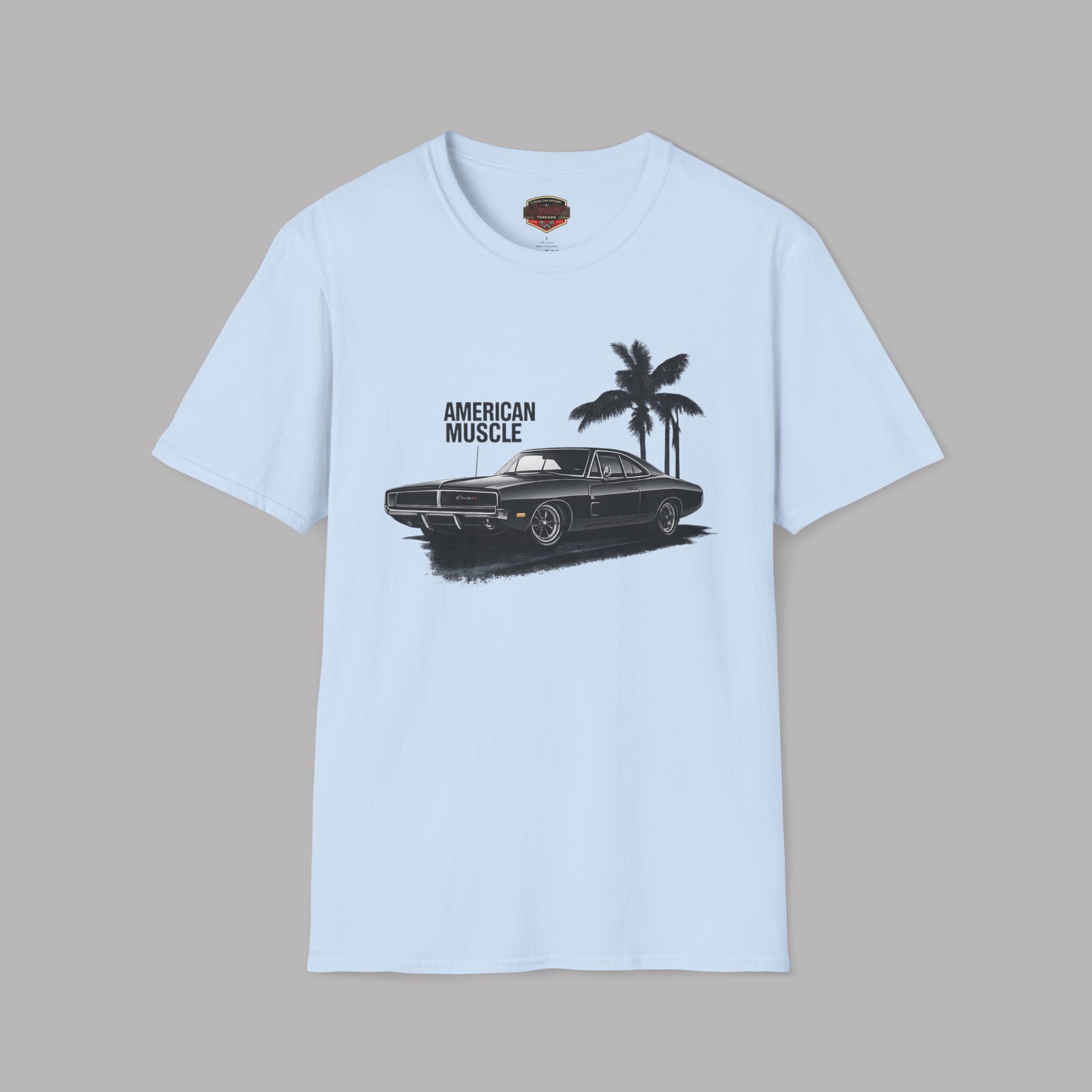 Light blue t-shirt with a graphic of a car and palm trees on a gray background
